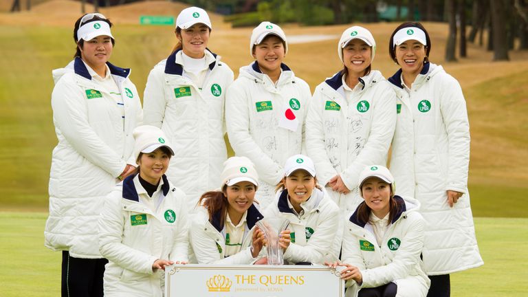 The Japan team celebrate with the trophy after winning The Queens