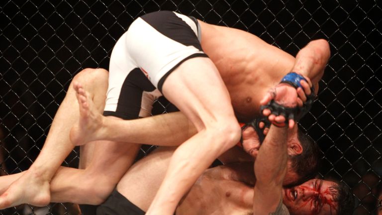 Luke Rockhold (top) grapples with Chris Weidman in their middleweight title fight during UFC 194 on December 12, 2015 in Las 
