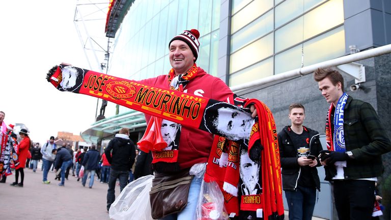 A street trader sells Jose Mourinho Manchester United scarves before the Barclays Premier League match against Chelsea.