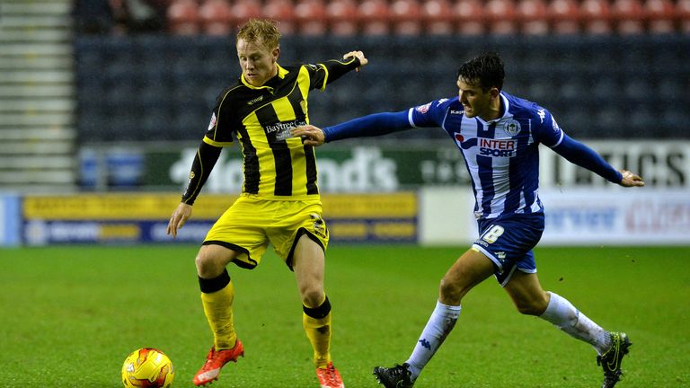 Burton Albion's Mark Duffy battles for the ball with Wigan Athletic's Don Cowie, during the Sky Bet League One match at the DW Stadium, Wigan.