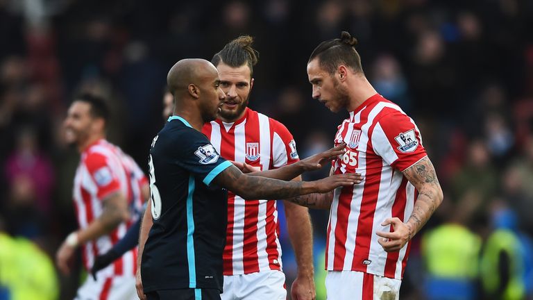 Marko Arnautovic (R) and Fabian Delph (L) argue after the Barclays Premier League match between Stoke City and Manchester City