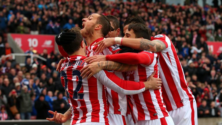 Marko Arnautovic (2nd L) celebrates scoring Stoke City's first goal with his team mates during the Barclays Premier League match against Manchester City
