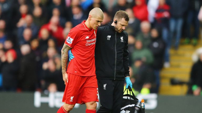 An injured Martin Skrtel of Liverpool is given assitance as he is substituted at Watford