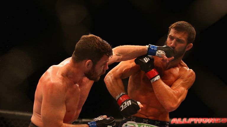 Michael Bisping connects with a left to the face of Luke Rockhold in their middleweight fight  during the UFC Fight Night 