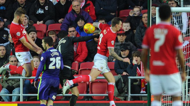 Nathan Baker (l) heads Bristol City into the lead