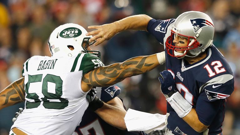 Jason Babin #58 of the New York Jets tackles Tom Brady #12 of the New England Patriots during the second quarter at Gillette Sta