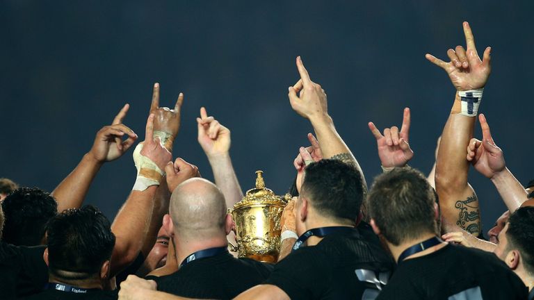The victorious New Zealand players celebrate with the Webb Ellis Cup during the 2015 Rugby World Cup Final match between New Zealand and Australia