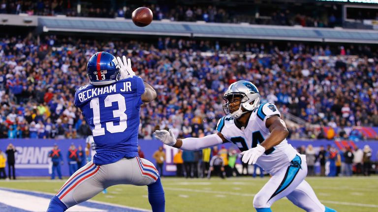 Odell Beckham #13 of the New York Giants scores a game tying touchdown against Carolina Panthers as Josh Norman looks on