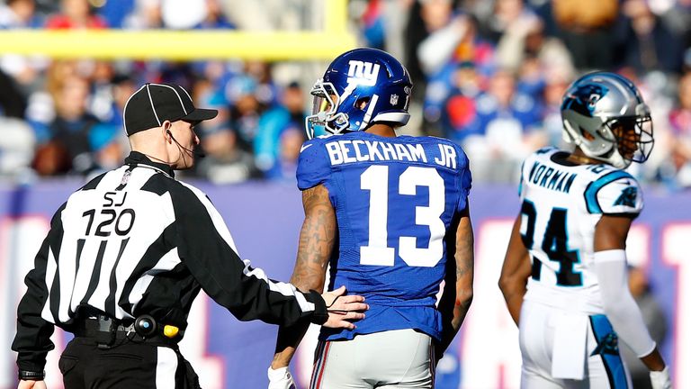 Odell Beckham of the New York Giants talks with a referee after a play with Josh Norman of the Carolina Panthers 
