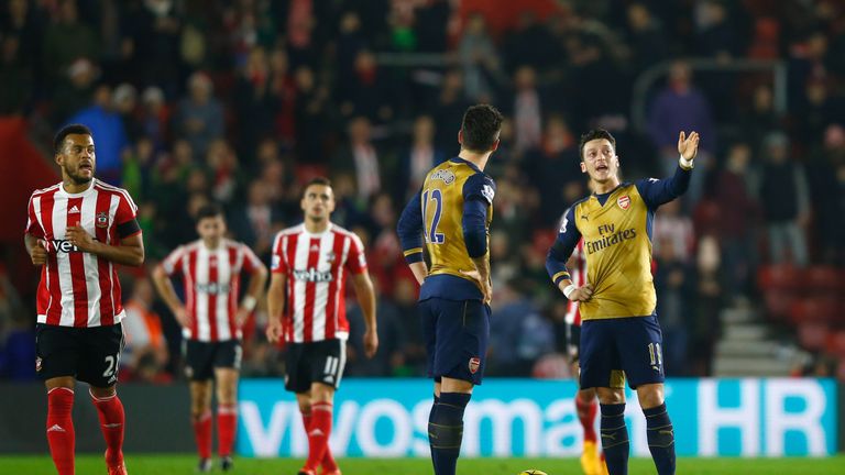 Olivier Giroud and Mesut Ozil of Arsenal in discussion as Southampton score their fourth goal during the Barclays Premier League