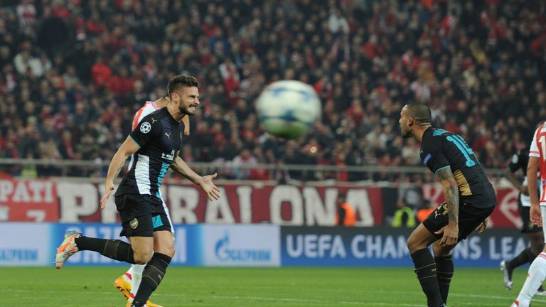 Olivier Giroud and Theo Walcott celebrate one of the Frenchman's three Arsenal goals at Olympiakos