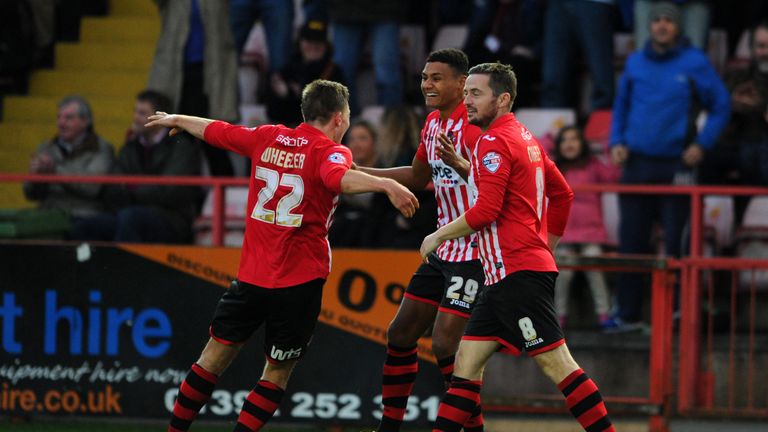 Ollie Watkins of Exeter City (middle) celebrates after scoring his side's second goal against Port Vale