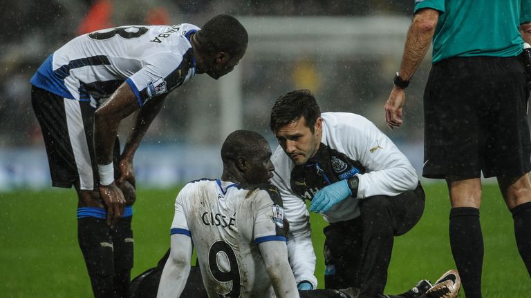 Newcastle striker Papiss Cisse receives treatment during the draw with Aston Villa  