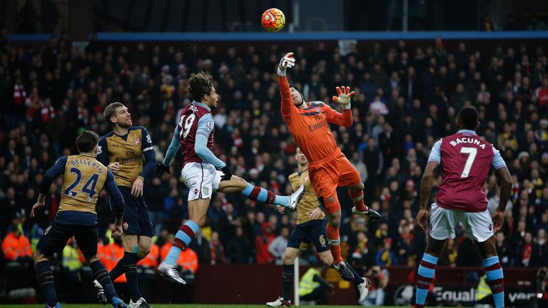 Arsenal's Czech goalkeeper Petr Cech (C) jumps to make a save during the English Premier League football match between Aston Villa