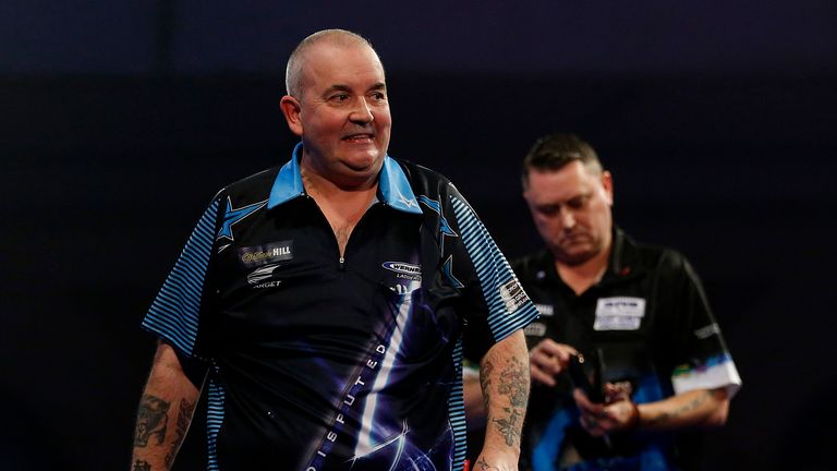 Phil Taylor (l) and Kevin Painter during their second round match at the PDC World Darts Championship