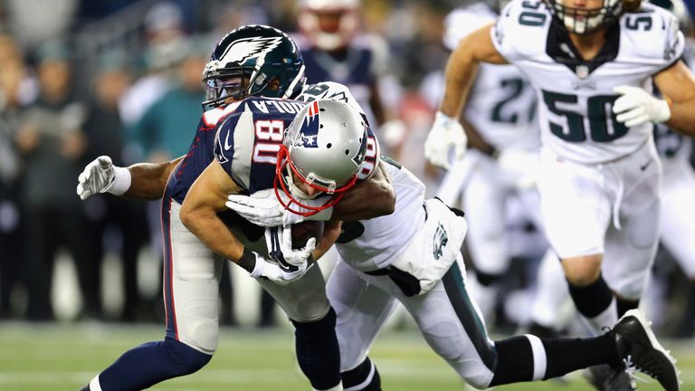 Walter Thurmond #26 of the Philadelphia Eagles tackles  Danny Amendola #80 of the New England Patriots at Gillette Stadium on D