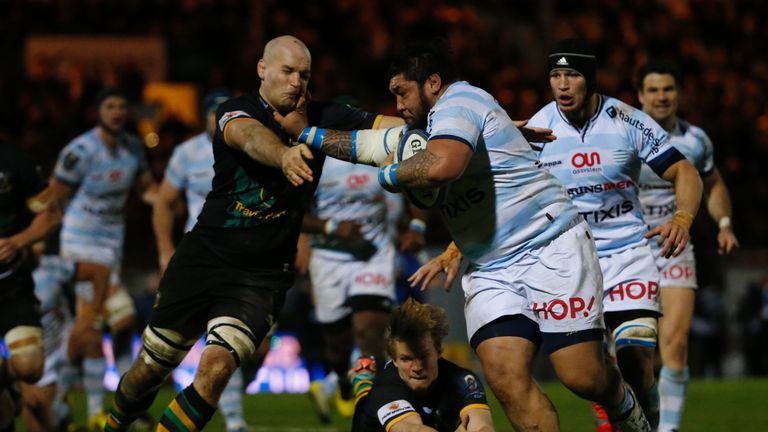 Racing-Metro's Tameifuna Ben (R) breaks through the defence during the European Cup rugby union match between Racing Metro 92 and Northampton Saints