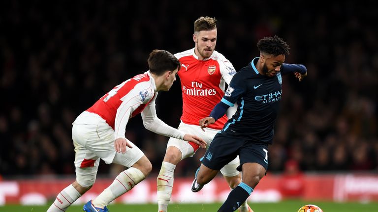 Raheem Sterling of Manchester City holds off Hector Bellerin  (L) and Aaron Ramsey during the Premier League match between Arsenal and Manchester City