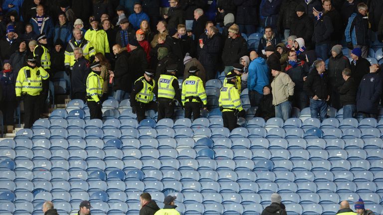 Rangers fans are removed from a section of Ibrox after part of the Sandy Jardine Stand appears to come away