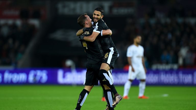 Leicester player Riyad Mahrez celebrates with Danny Drinkwater (L) after scoring the first goal against Swansea