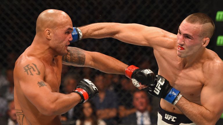 Rory MacDonald (right) punches Robbie Lawler