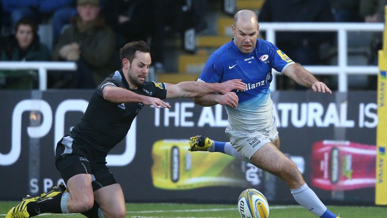 Saracens fly-half Charile Hodgson (right) competes for possession with Micky Young of Newcastle