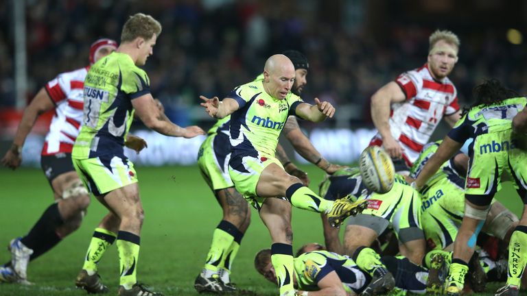 Sale Sharks scrum-half Peter Stringer clears his lines against Gloucester