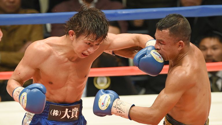 Japanese champion Ryoichi Taguchi (L) punches Colombian challenger Luis De La Rosa