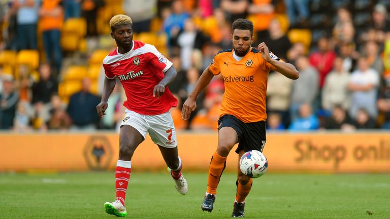Wolves defender Scott Golbourne (r) holds off Newport striker Medy Elito during the Capital One Cup First Round match 