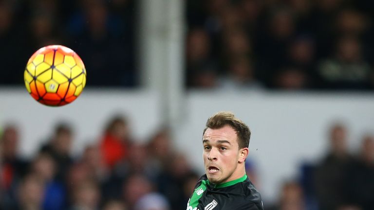 Shaqiri watches as the ball floats over Tim Howardn