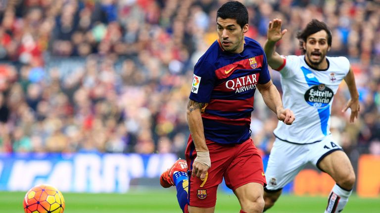 Luis Suarez battles for the ball