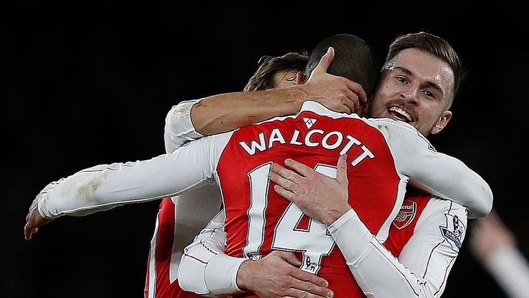 Arsenal's Theo Walcott (C) celebrates with Aaron Ramsey (R) after scoring his team's first goal
