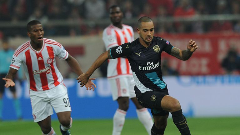 Theo Walcott of Arsenal breaks past Seba of Olympiakos during the UEFA Champions League group stage match on December 9, 2015
