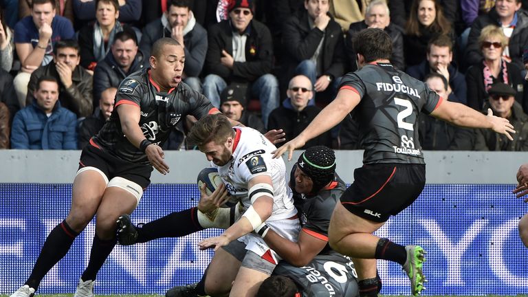 Thierry Dussautoir (3rd R) and scrum-half Sebastien Bezy breaks away from Ulster's center Stuart McCloskey (C) during the Champions Cup match Toulouse