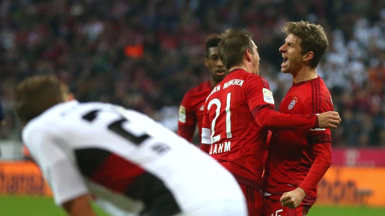 Philipp Lahm and Thomas Muller celebrate during the Bundesliga match between Bayern Munchen and FC Ingolstadt at Allianz Arena on December 12