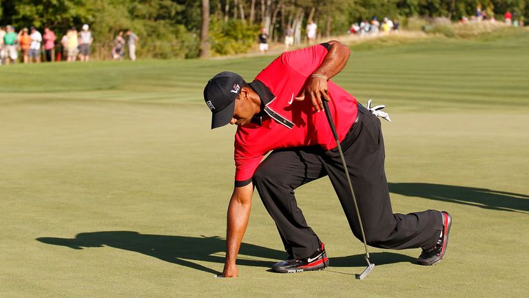 Woods struggled to bend over during the final round of the Barclays