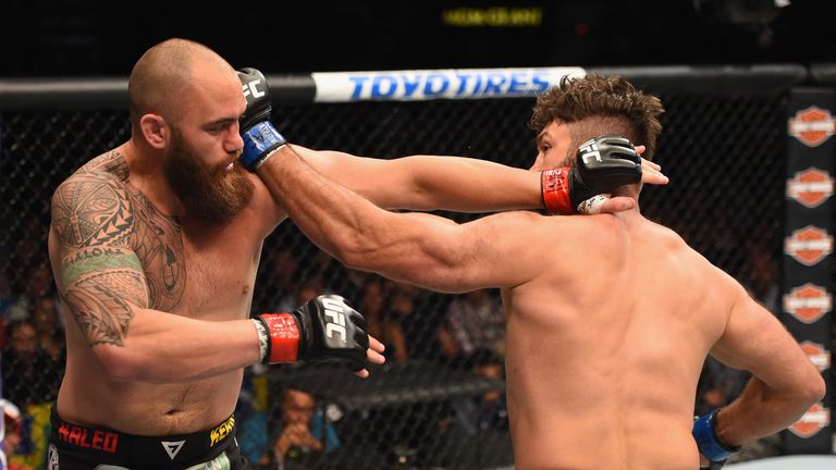 Andrei Arlovski (right) punches Travis Browne in their heavyweight bout during the UFC 187