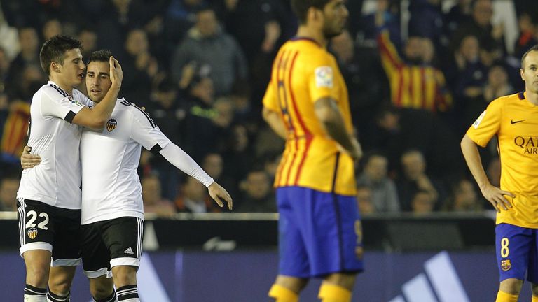Valencia's forward Santi Mina (L) celebrates his goal with Valencia's forward Paco Alcacer (2nd L) as they walk past 