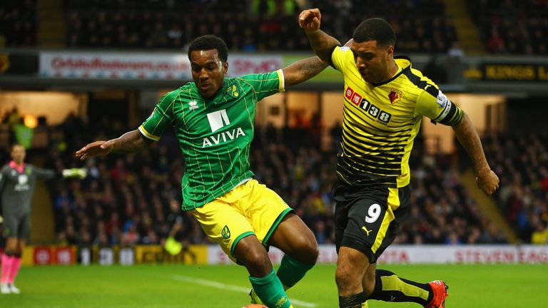 Andre Wisdom and Troy Deeney compete for the ball