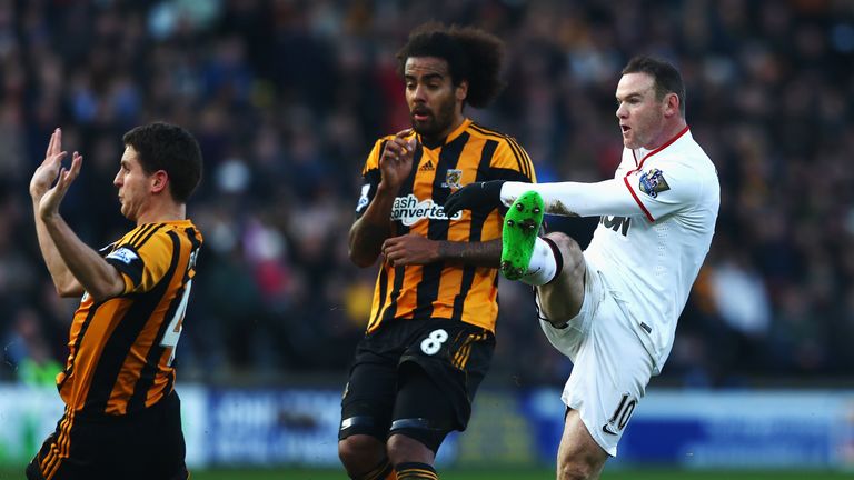 HULL, ENGLAND - DECEMBER 26:  Wayne Rooney (R) of Manchester United shoots and scores his sides second goal during the Barclays Premier League match betwee