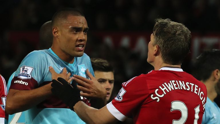 Bastian Schweinsteiger (r) clashes with Winston Reid (l) 