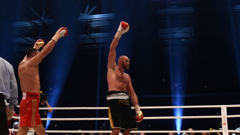 British Tyson Fury (R) celebrates after the WBA, IBF, WBO and IBO title bout against Ukrainian world heavyweight boxing champion Wladimir Klitschko