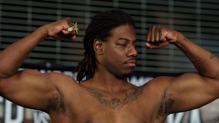 Boxer Charles Martin of the US flexes his muscles while weighing in at Barclay's Center January 15, 2016 in New York