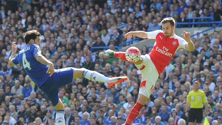 Aaron Ramsey of Arsenal challenged by Cesc Fabregas of Chelsea during the Barclays Premier League match 