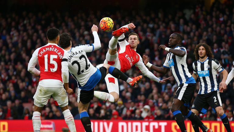 Aaron Ramsey of Arsenal and Daryl Janmaat of Newcastle United compete for the ball