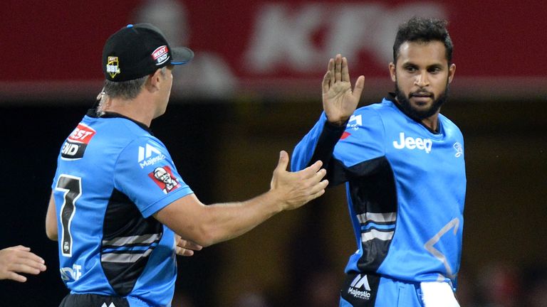 BRISBANE, AUSTRALIA - JANUARY 08: Adil Rashid of the Strikers celebrates taking the wicket of Chris Lynn of the Heat during the Big Bash League match betwe