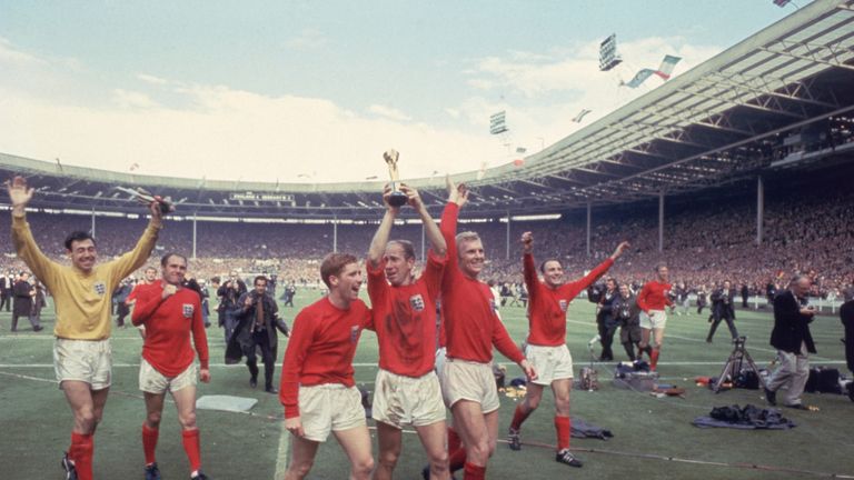 Bobby Charlton (with Alan Ball) raises the Jules Rimet trophy in the air  following England's win over West Germany in the World Cup Final at Wembley