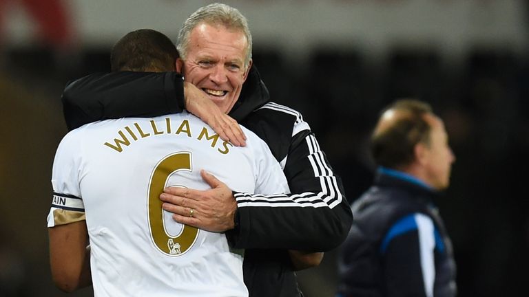 SWANSEA, WALES - JANUARY 18:  Swansea interim manager Alan Curtis hugs Ashley Williams after the Barclays Premier League match between Swansea City and Wat