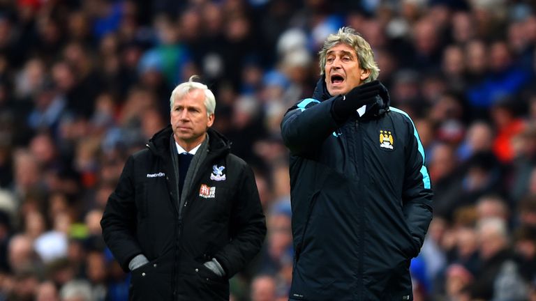 Alan Pardew (L) and Manuel Pellegrini on the touchline during Crystal palace's game at Manchester City