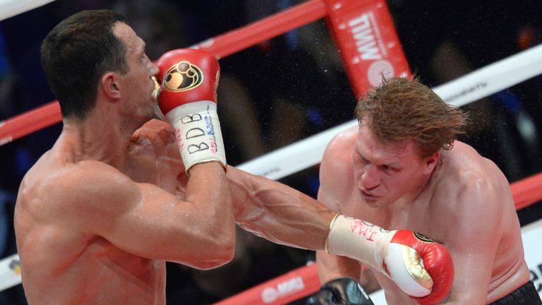 Ukrainian heavyweight boxing world champion Vladimir Klitschko (L) punches Russian heavyweight boxer Alexander Povetkin during their fight in Moscow on Oct